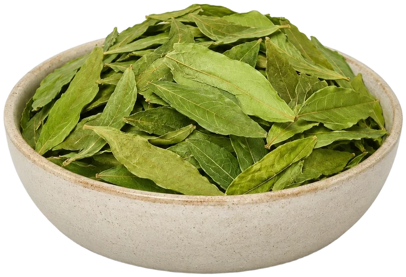 Ceramic bowl of herbs with a tea cup behind
